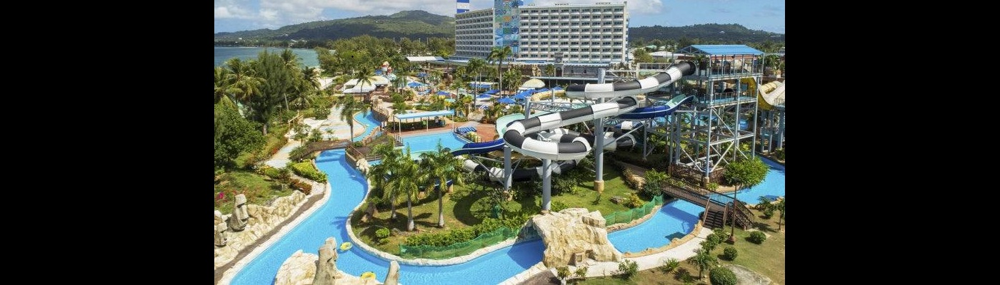 Aerial view of a large outdoor water park with colorful slides